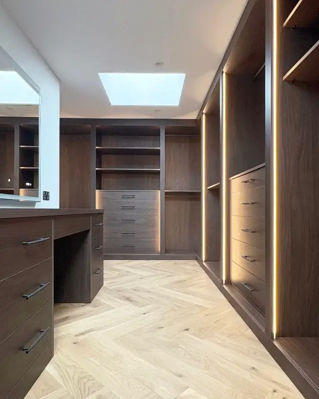 ⭐🏠⭐ A timeless and sophisticated dressing room, with vertical strip lighting that really enhances the space and brings out the wood tones. This has created a dressing room with a real wow factor. We love the combination of having the herringbone oak flooring contrasting with the walnut tones on the furniture. ⭐🏠⭐

We are a small team based in Newbury and we design, manufacture and install bespoke fitted furniture. feel free to get in touch to discuss your project today 

 #HomeImprovement #luxurydesign #InteriorDesign #joinery #bespokefurnituredesign #dressingroom #BespokeJoinery #wardrobedesign #FittedWardrobes #bespokewardrobe