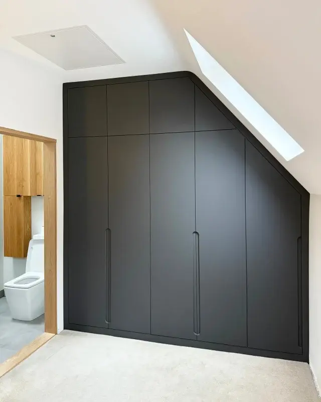 A striking graphite angled wardrobe with a smooth matte finish brings a bold, contemporary feel to this sloped-ceiling room. Set against the warm oak details, it creates a beautifully balanced contrast while making clever use of every angle.

Bespoke storage, designed to fit the space perfectly. 👌

#BespokeWardrobe #FittedFurniture #MadeToMeasure #CustomStorage #InteriorDesign #ModernInteriors #LoftConversion #GraphiteWardrobe #OakDetails #BedroomDesign
