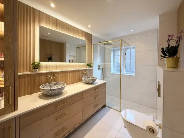 A luxury 5 star bathroom transformation in Newbury, combining natural textures with elegant finishes.

This space features bleached American oak cabinetry paired with matching ribbed oak wall panelling, creating a warm and contemporary feel. The subtle white veining throughout the bathroom keeps the design light and refined, while the quartz worktop and brass sanitaryware add a touch of luxury.

Finished with these incredible ceramic basins from @londonbasincompany, which perfectly complete the space.

A big thank you to @green_heating for their help with the plumbing to bring this design to life.

At Thomas Burridge, we design, manufacture and install bespoke, made to-measure furniture for every room in the home. 🏡

 #highendbathrooms #highendbathroom #highendbathroomremodel #bespokefurniture #InteriorDesign #joinery #madetomeasure #BespokeJoinery #luxurydesign #ElegantLiving #CustomFurniture #cabinetry #bespokecabinetry #bespokejoinery